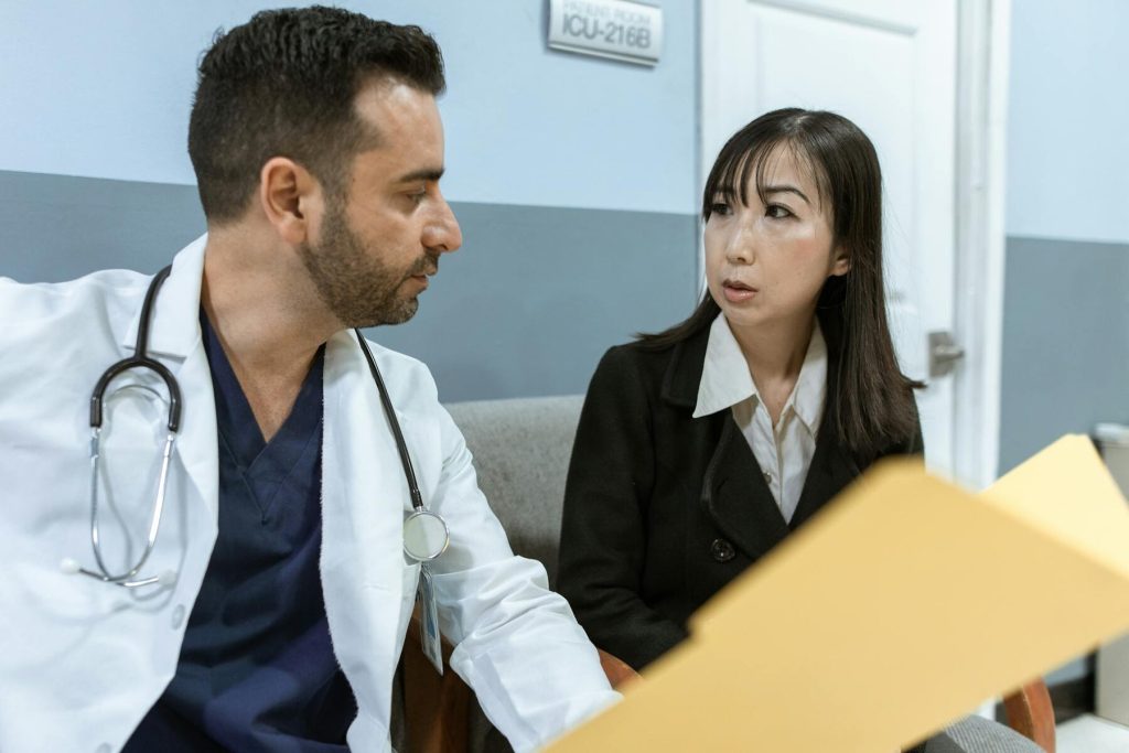 A doctor discusses medical documents with a concerned individual