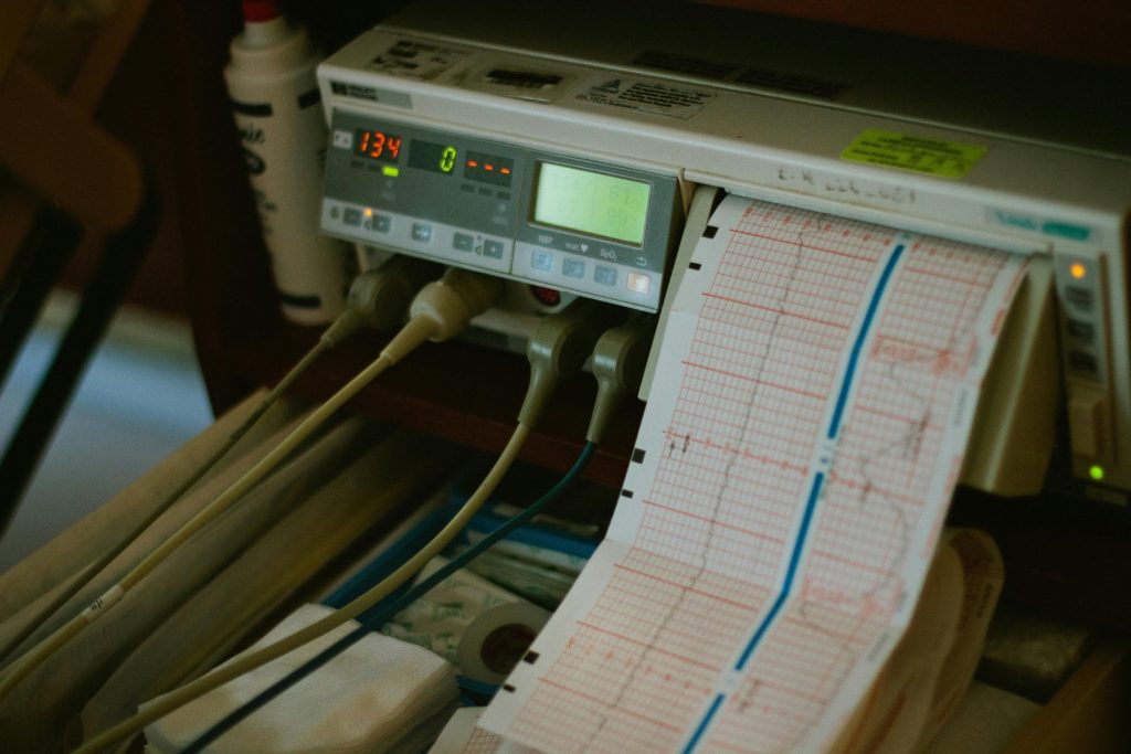 A medical monitoring device actively recording data on a printed graph paper strip