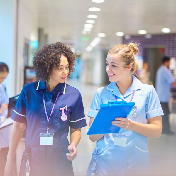 Two nurses walking alongside one another