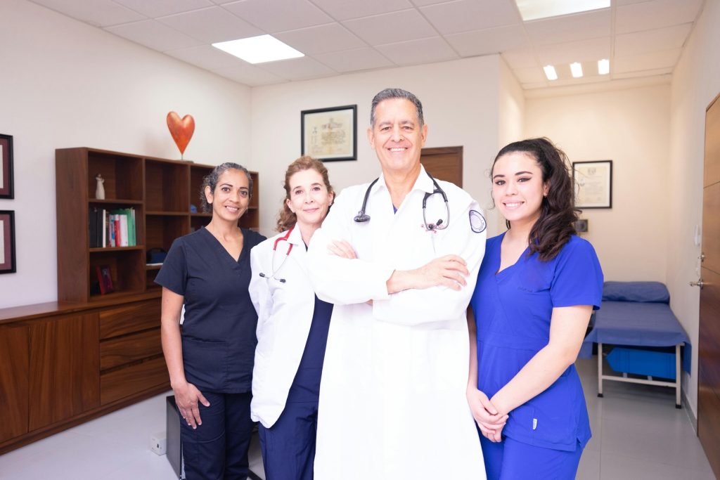 A doctor with his nurses on his side