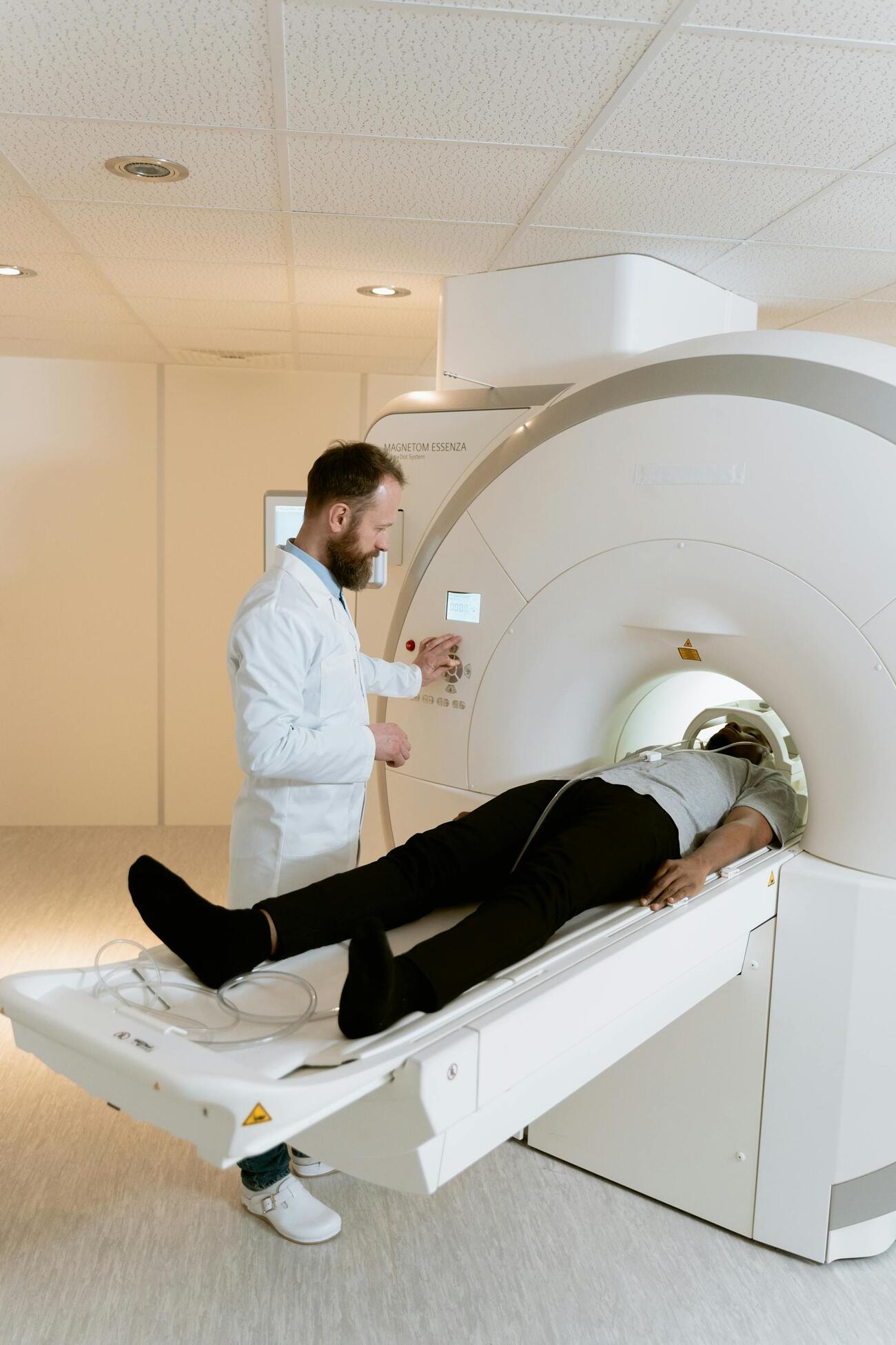 A healthcare worker using an MRI machine to examine a patient